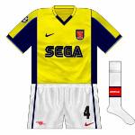 1999-2000:
The following year, Arsenal were drawn with Barcelona, who had navy shorts and socks in their early years with Nike. Though yellow versions would later appear, for the trip to the Nou Camp, Arsenal went yellow-white-white.